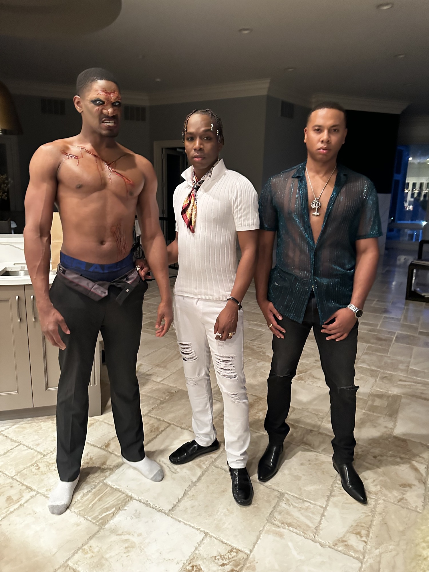 Three cast members together on set
